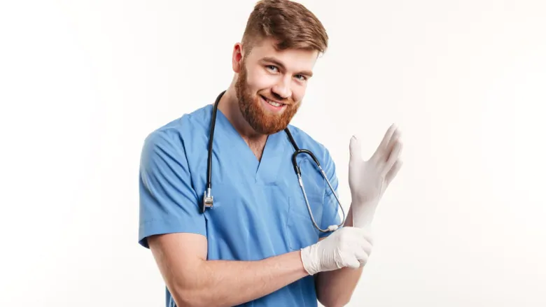 Doctor smiling, putting his glove on getting ready to examine some balls