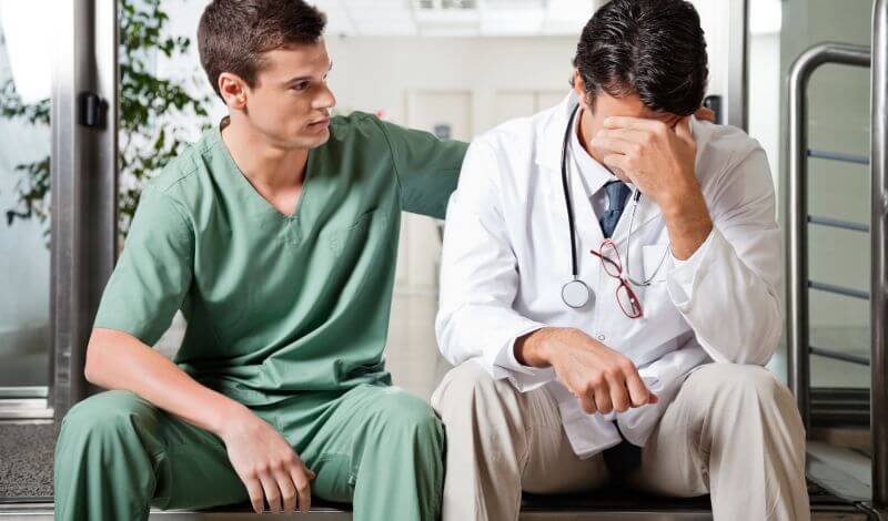 doctor comforting another doctor